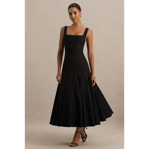Magnolia | Robe mi-longue noire à décolleté arrondi taille basse et détails à volants