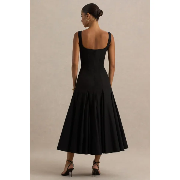 Magnolia | Robe mi-longue noire à décolleté arrondi taille basse et détails à volants