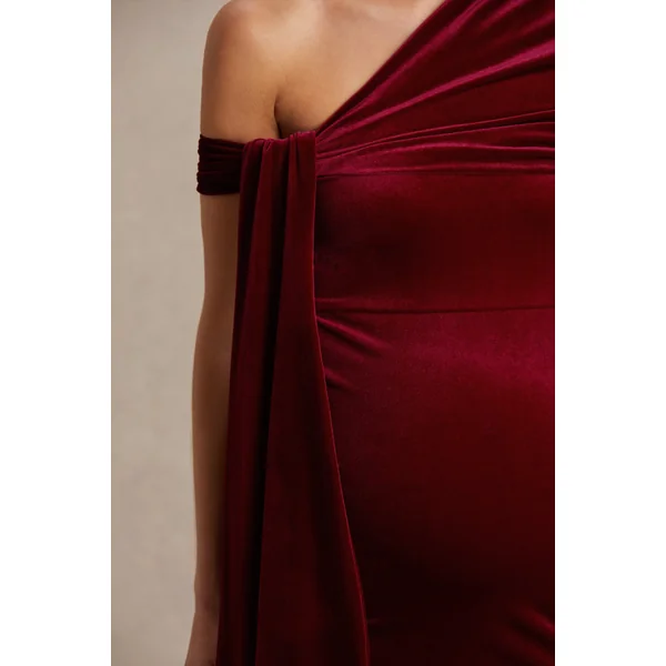 Zena | Robe mi-longue de maternité en velours rouge bordeaux à encolure asymétrique avec détail noué